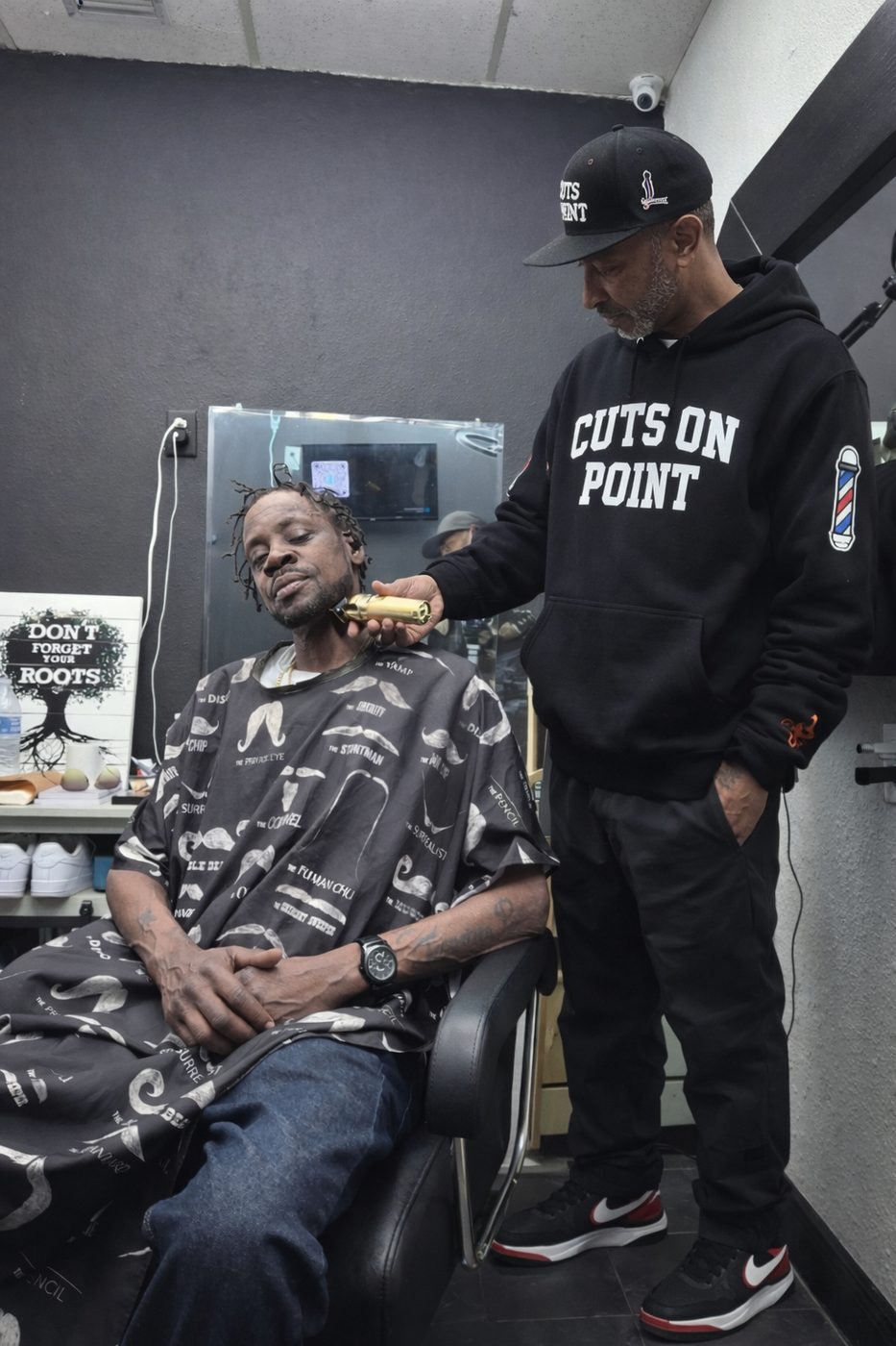 Barber giving a beard trim to a client at Cuts On Point